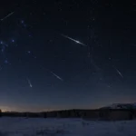 Geminids meteor shower streaking across a dark winter night sky