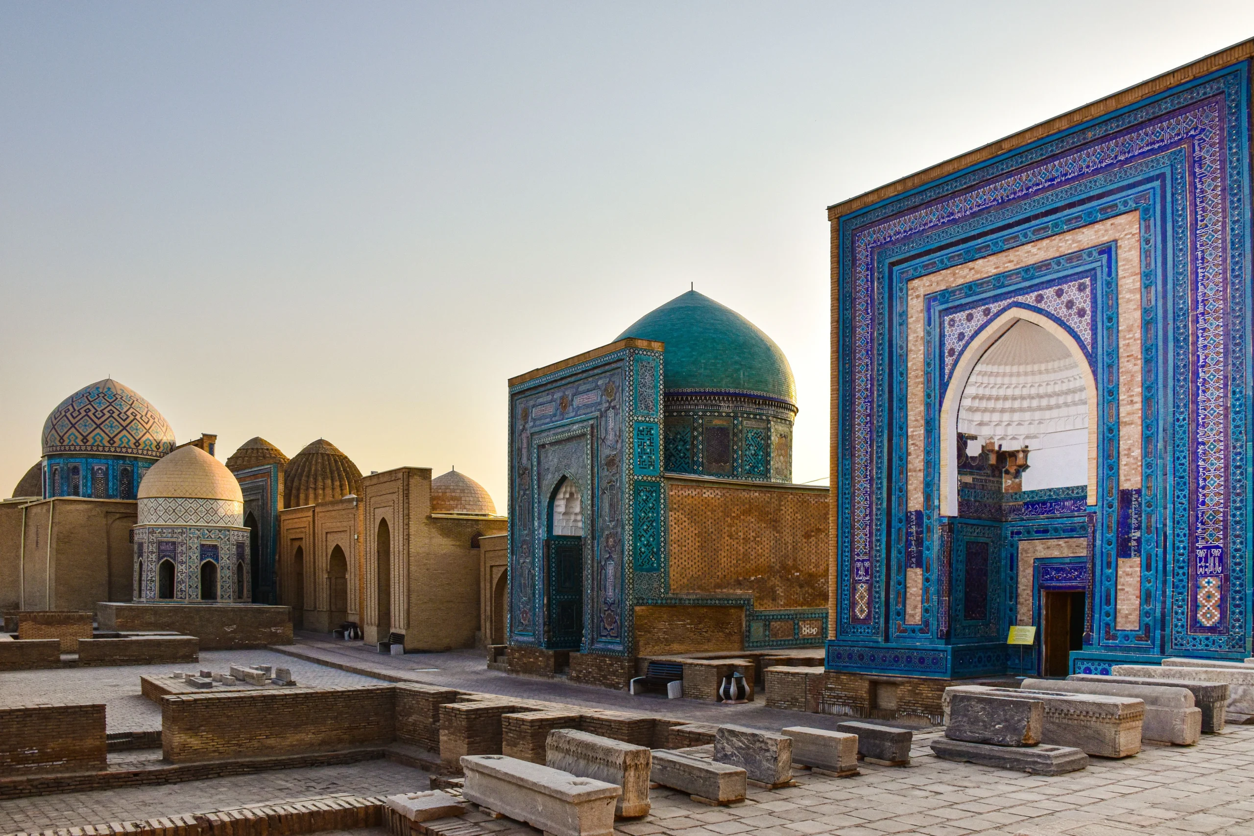 Stepped avenue lined with intricate blue and turquoise tiled mausoleums at Shah-i-Zinda in Samarkand.